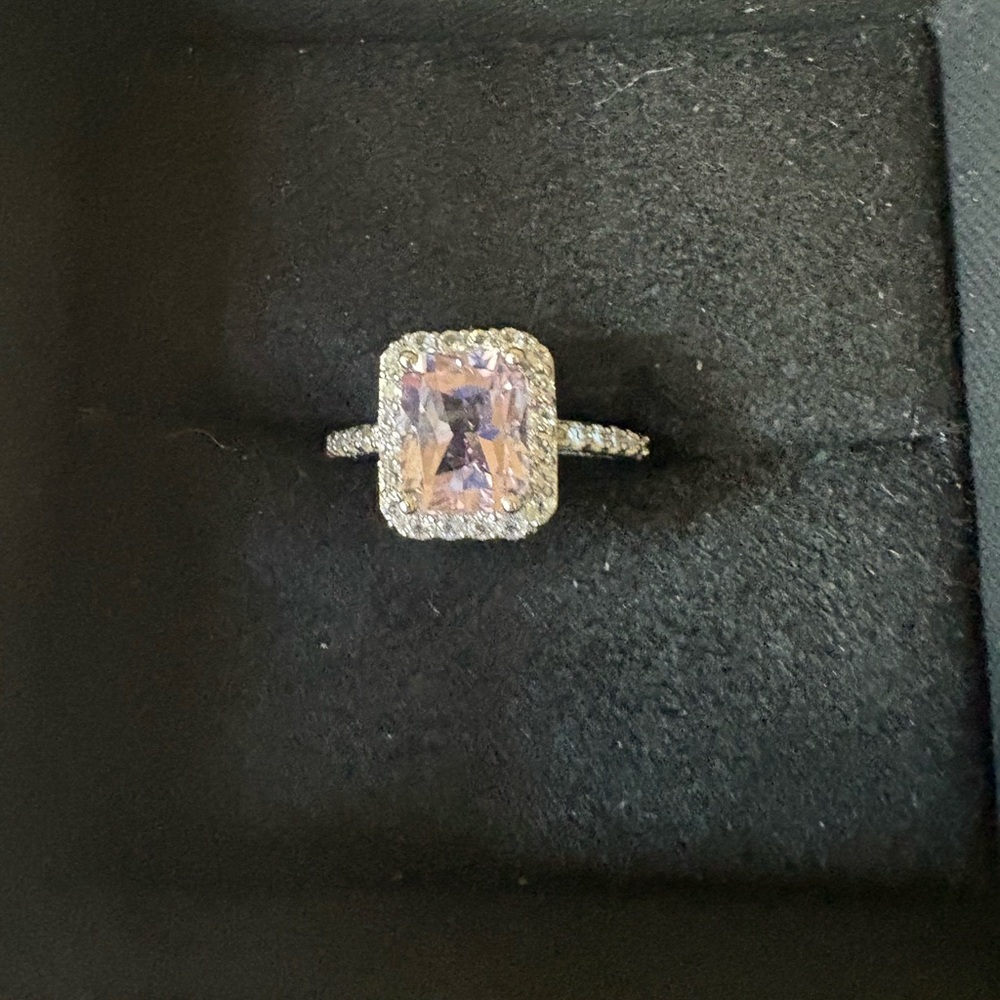 Light purple emerald cut stone with halo cz diamonds